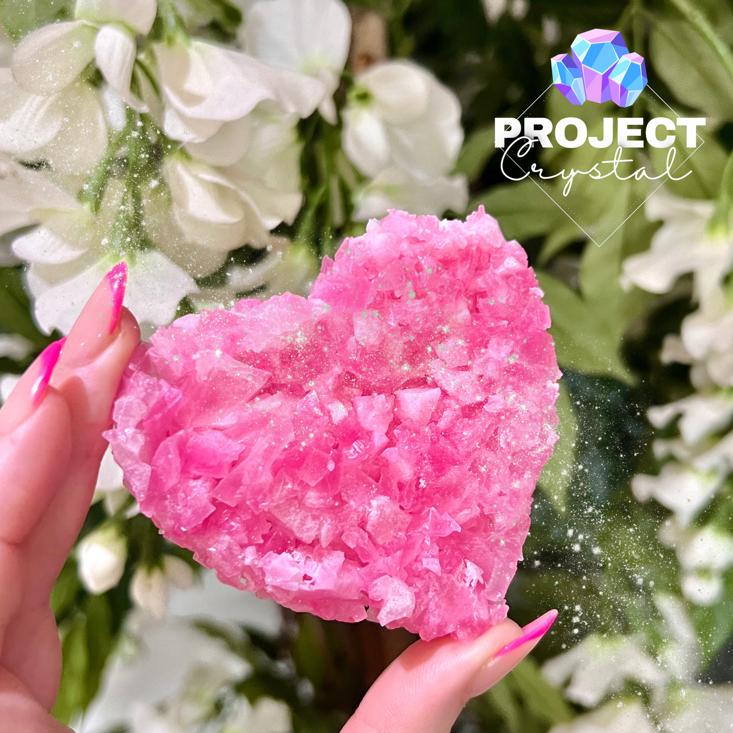 A floral lychee heart shapes cluster made to look like real crystals, vivid pink in colour.