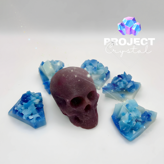A crystal candy skull in watermelon flavour surrounded by blue and white edible crystals.