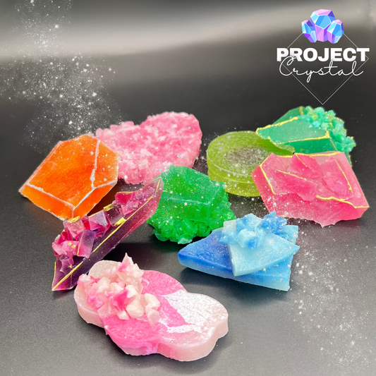 An erray of edible crystals on display. Colourful crystal candy hand cut and painted, made to look like real crystals and gems.